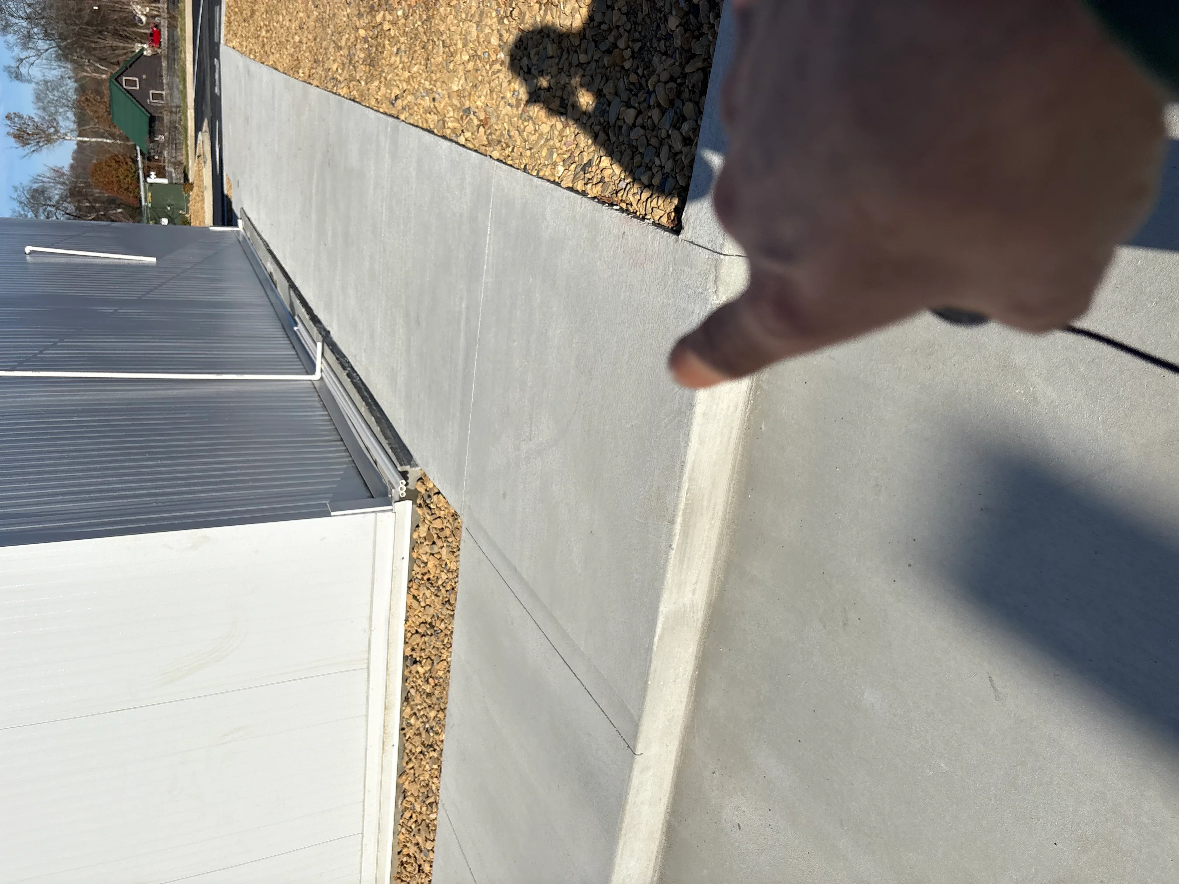 Newly installed concrete driveway with finished edges and proper grading