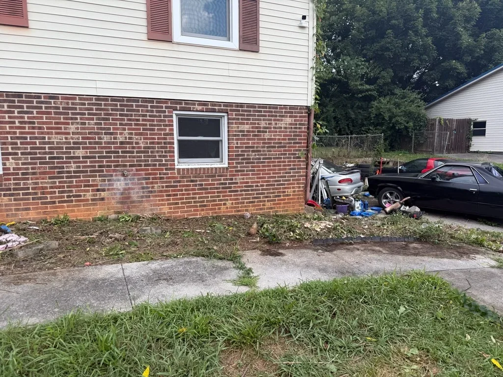 Newly installed concrete driveway and walkway in front of brick residential home