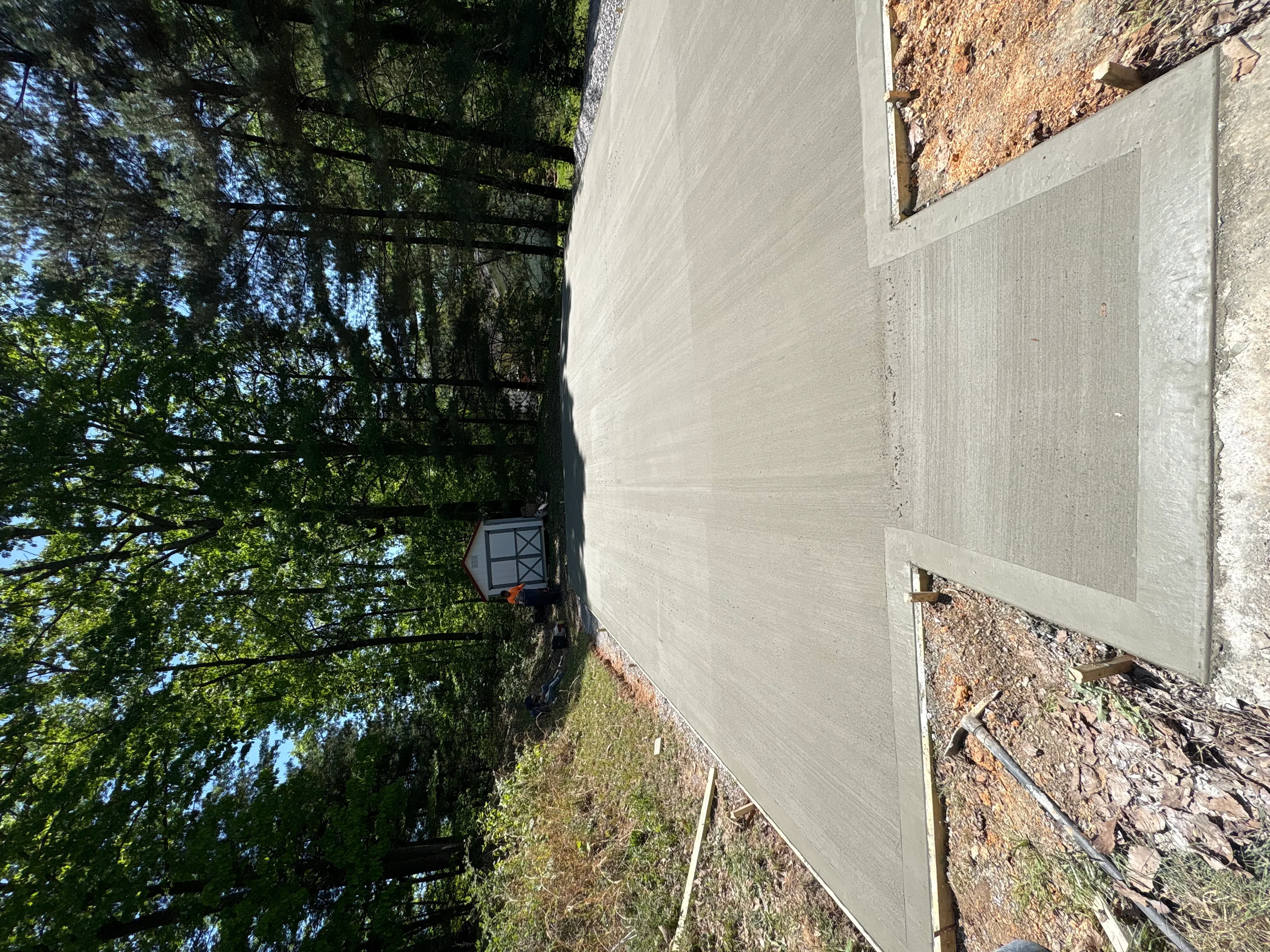 Newly installed concrete driveway with finished surface and clean edges