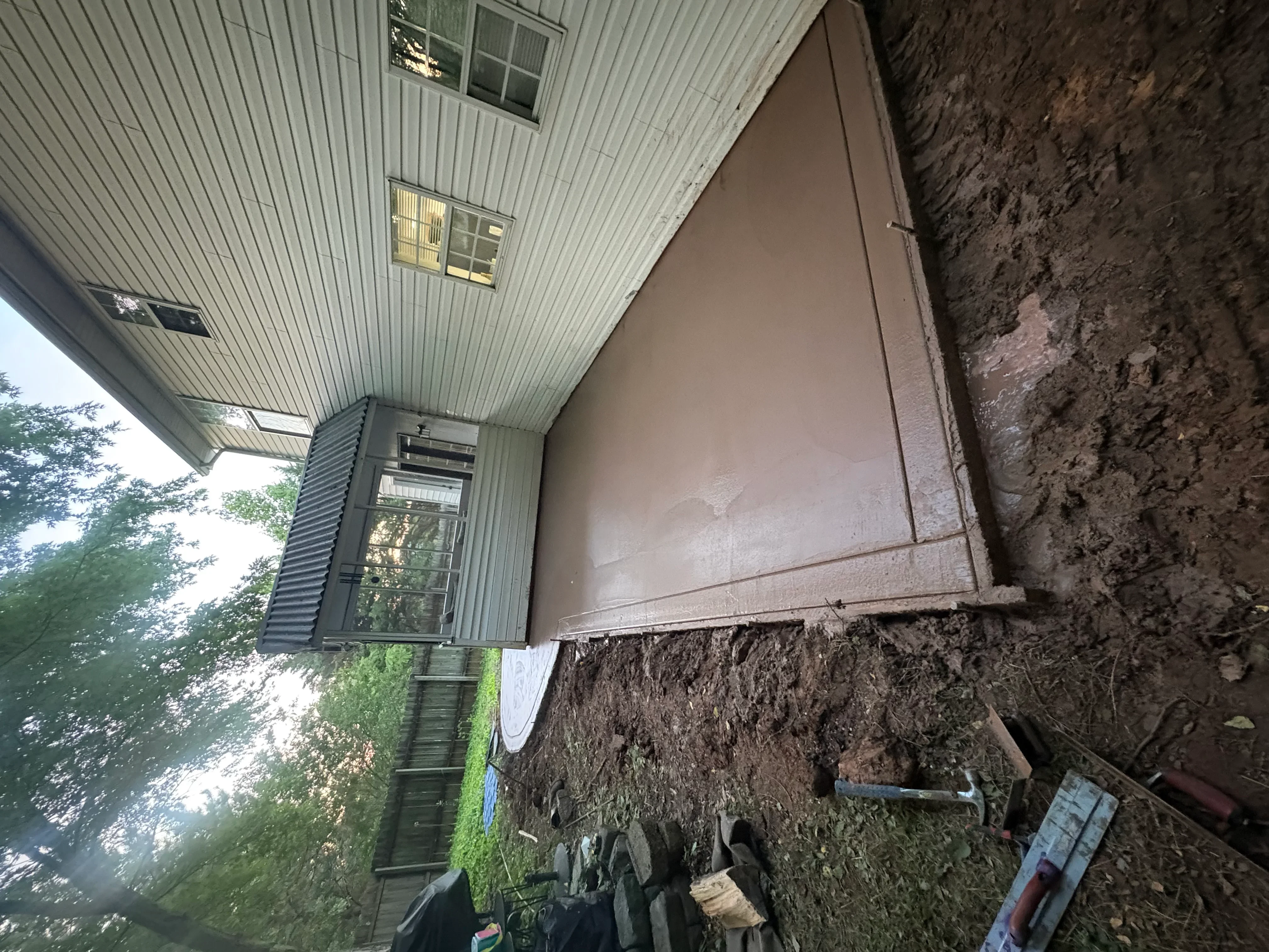 Concrete foundation repair showing stabilized wall and corrected settling on residential home