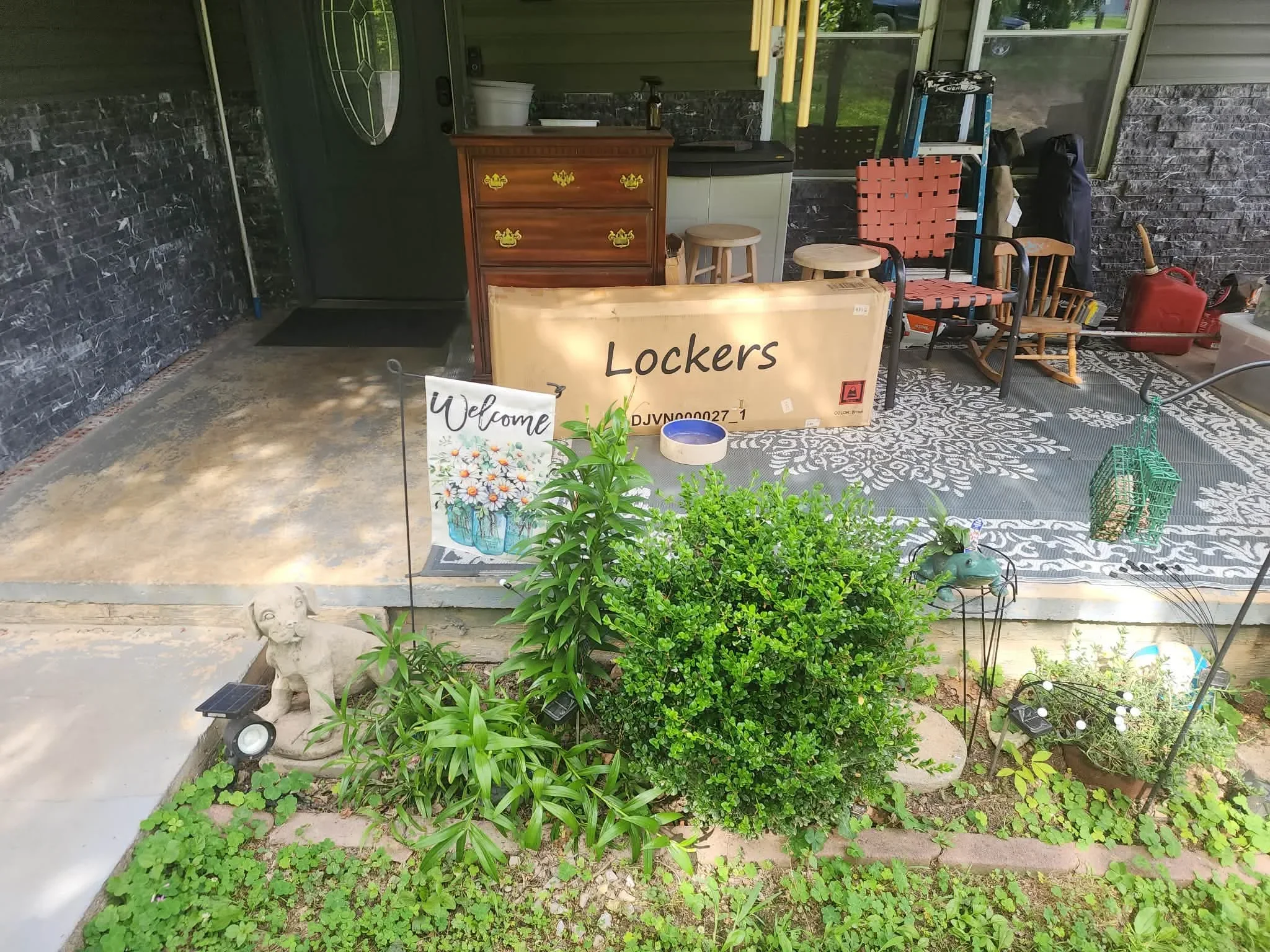 Finished concrete patio and entryway with landscaping and welcome signage